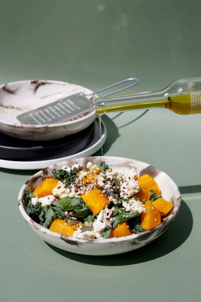 Delicious pumpkin and feta cheese salad drizzled with olive oil, perfect for a healthy meal.