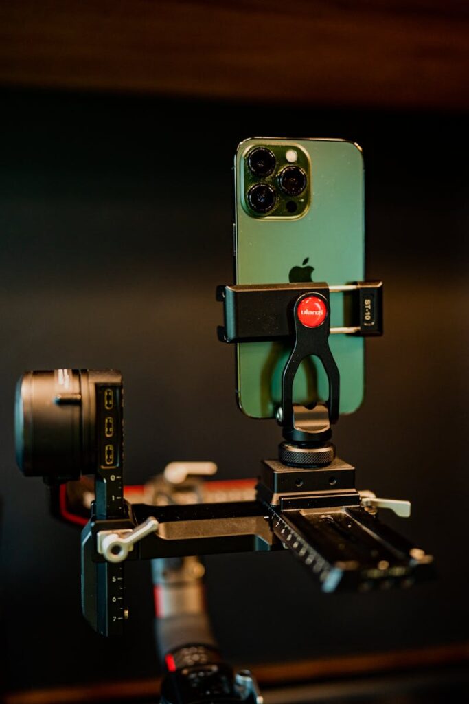 Close-up of a modern smartphone mounted on a tripod stabilizer, showcasing advanced technology.