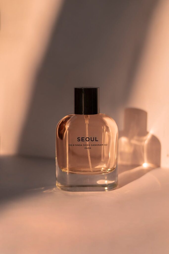 A sophisticated perfume bottle labeled 'Seoul', beautifully lit with warm tones and shadows.