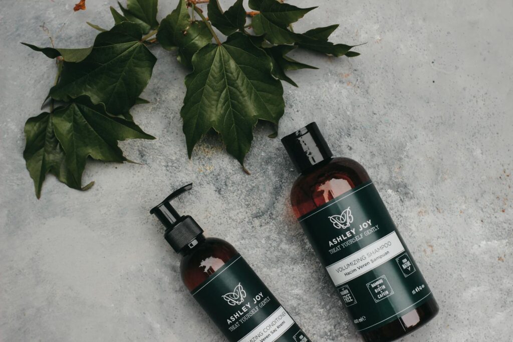 Natural volumizing shampoo and conditioner with green leaves for organic hair care.