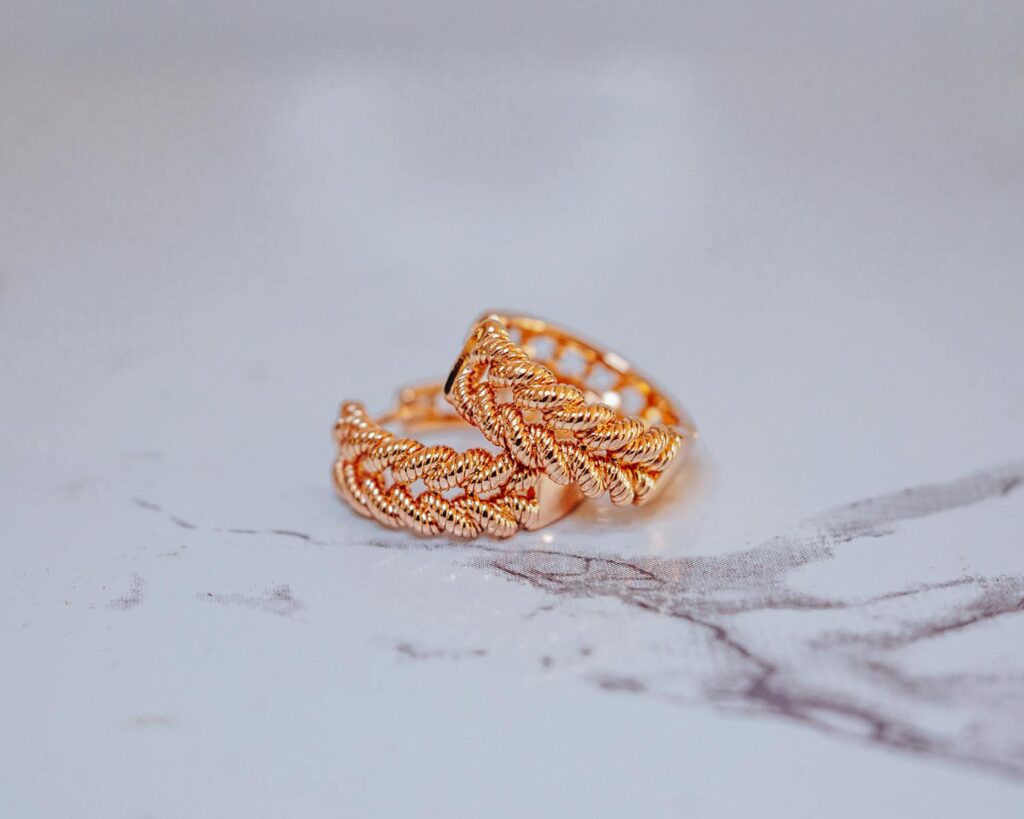Close-up of a stylish gold snake ring on a marble surface, showcasing intricate design and elegance.