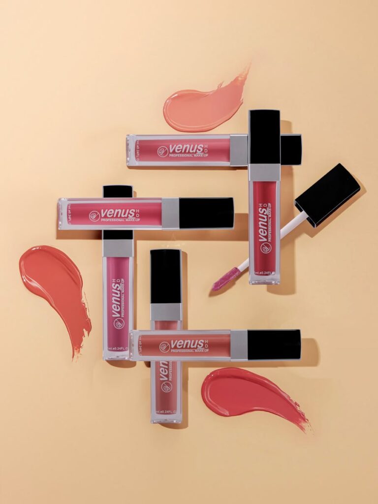 A stylish arrangement of colorful lipsticks on a neutral background, showcasing modern beauty.