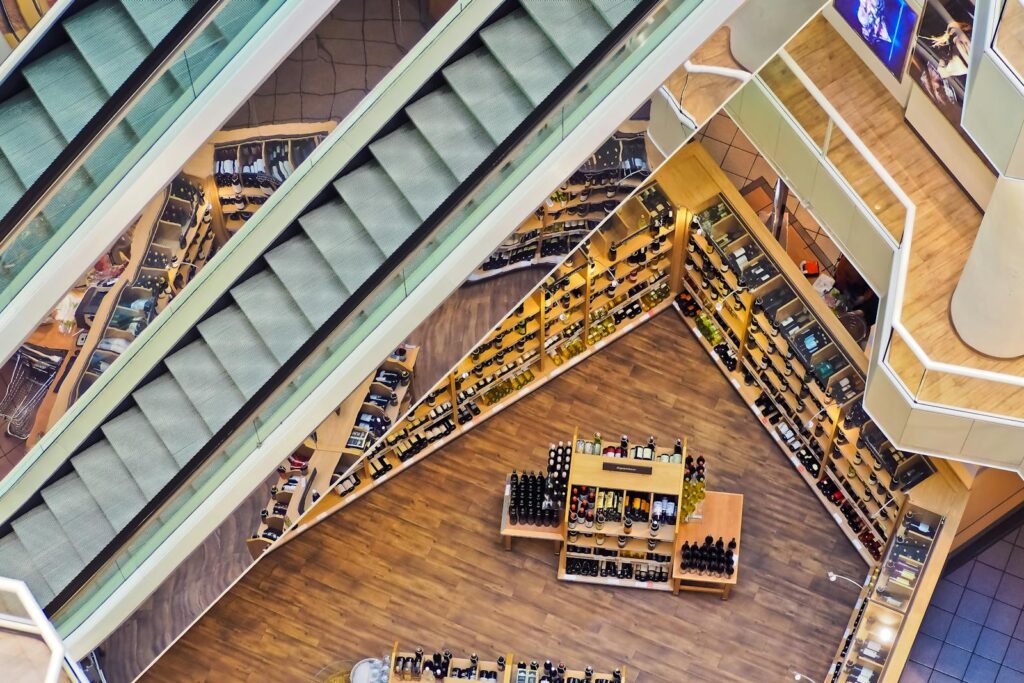 Aerial view of a stylish shopping mall showcasing escalators and well-organized retail displays.