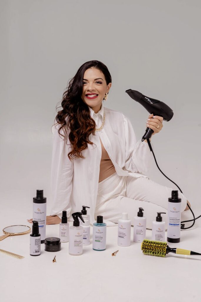 A stylist with hair care products and a blow dryer, showcasing a modern beauty setup.