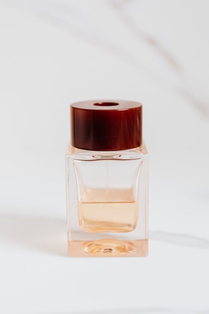 A luxury perfume bottle with a wooden cap on a minimal white background, embodying elegance and sophistication.