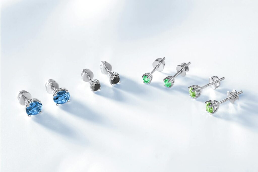 A collection of elegant gemstone stud earrings beautifully arranged on a white background.