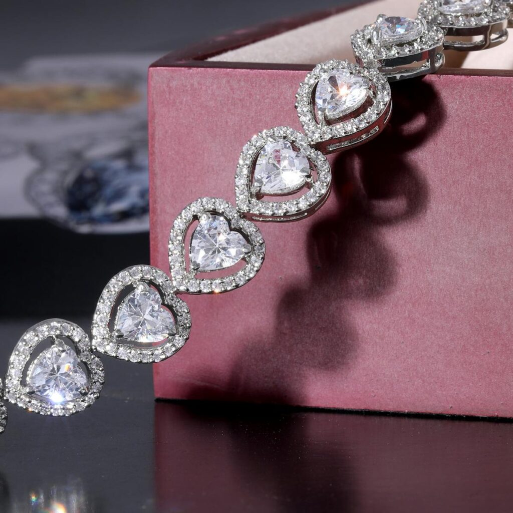 A luxurious heart-shaped diamond bracelet elegantly displayed on a maroon gift box, symbolizing opulence and romance.
