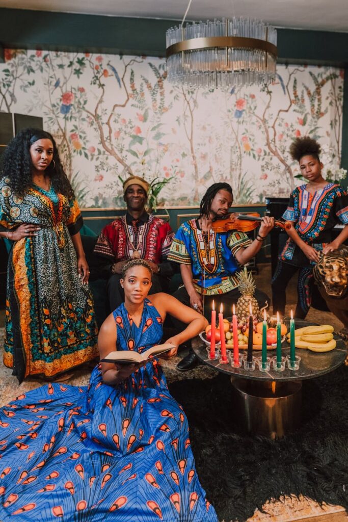 Diverse group celebrating Kwanzaa with traditional clothing and vibrant Kinara candles.
