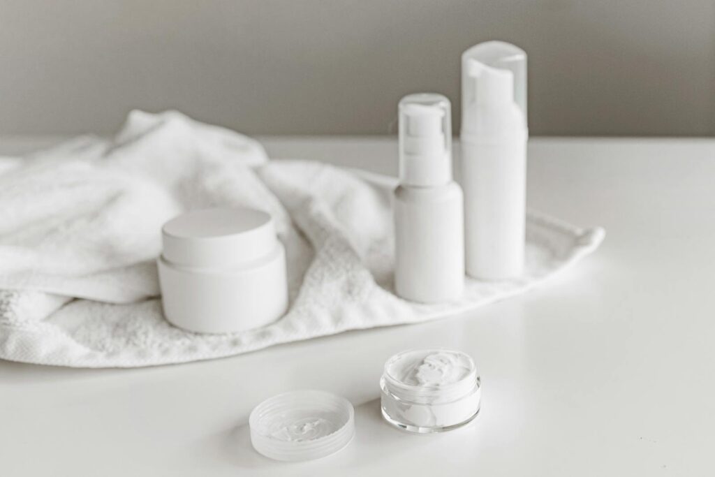 Elegant display of skincare products on a white surface, highlighting simplicity and purity.