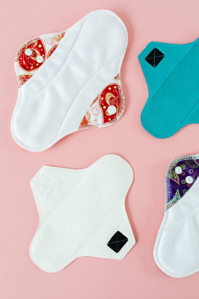 Top view of eco-friendly menstrual pads on pink surface.
