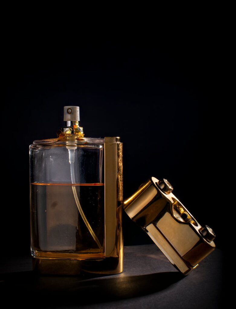 Sophisticated perfume bottle with gold details on a black backdrop, exuding luxury.