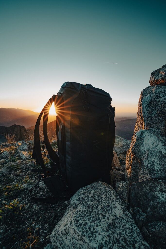 backpack, rocks, sun