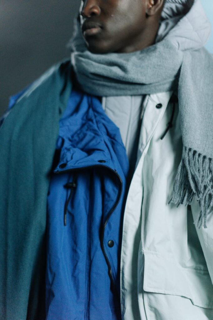 Close-up of a male model wearing layered winter clothing, perfect for cold weather fashion.