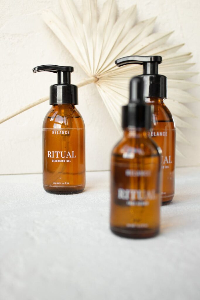 Close-up of amber glass bottles of Ritual cleansing oil with elegant minimalist design.