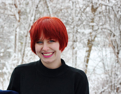 Red Long Pixie Cut & Black Mock Turtleneck with a Snowy Background