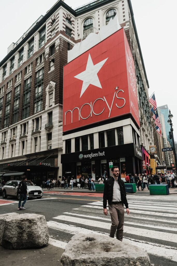 Pedestrians crossing street in front of Macy's in New York City.