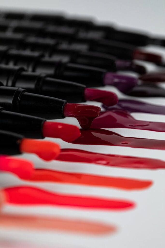 Colorful lipstick collection smeared on a white background, showcasing vibrant hues.