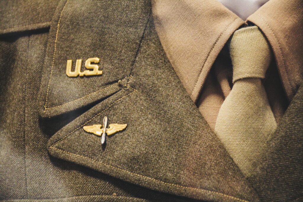 Close-up of a vintage U.S. military uniform featuring badge and tie, representing historical military apparel.