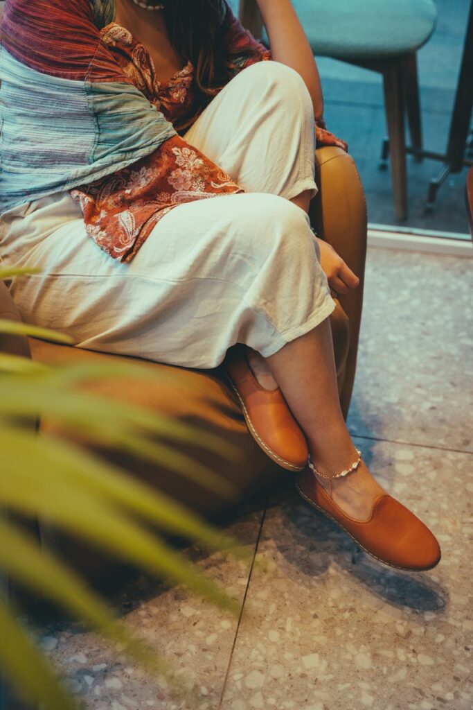 Bohemian fashion with colorful textiles and stylish shoes indoors.