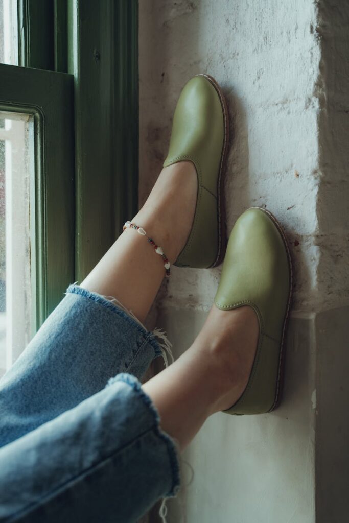 Casual fashion featuring green loafers and denim jeans, perfect for a laid-back style.