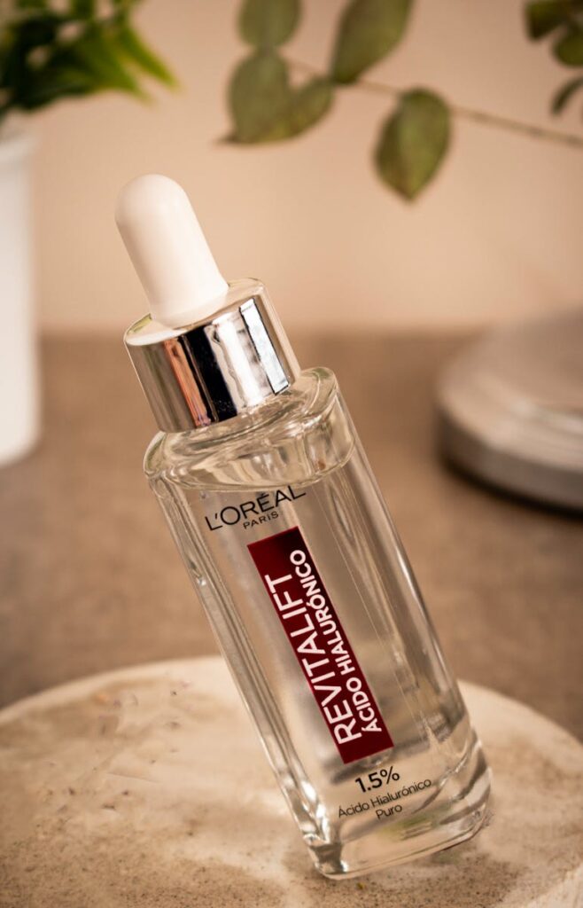 Close-up of L'Oréal Revitalift hyaluronic acid serum bottle with dropper.