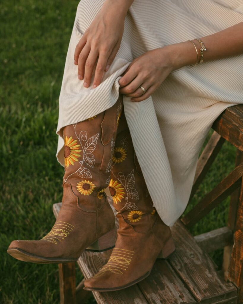 Fashionable brown cowboy boots with sunflower embroidery, perfect for autumn style.