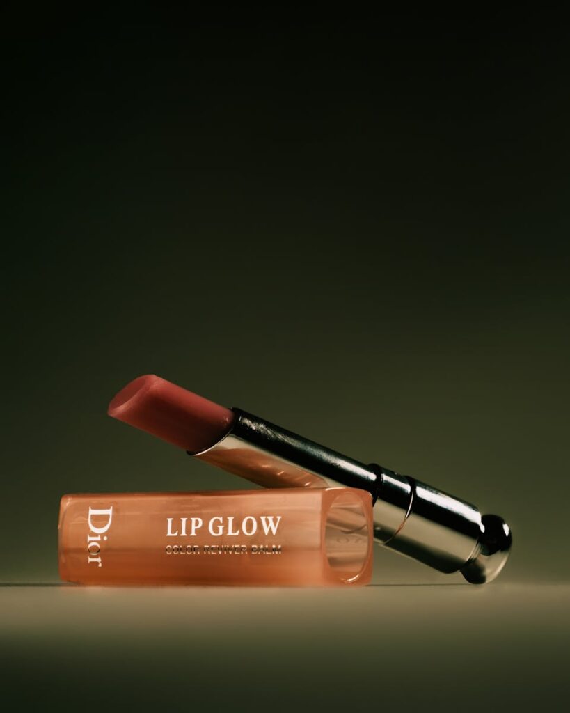 Chic lipstick and lip balm set against a dramatic dark setting, ideal for beauty showcases.