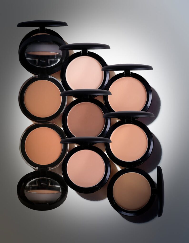 A selection of compact powders in various shades, suitable for diverse skin tones.