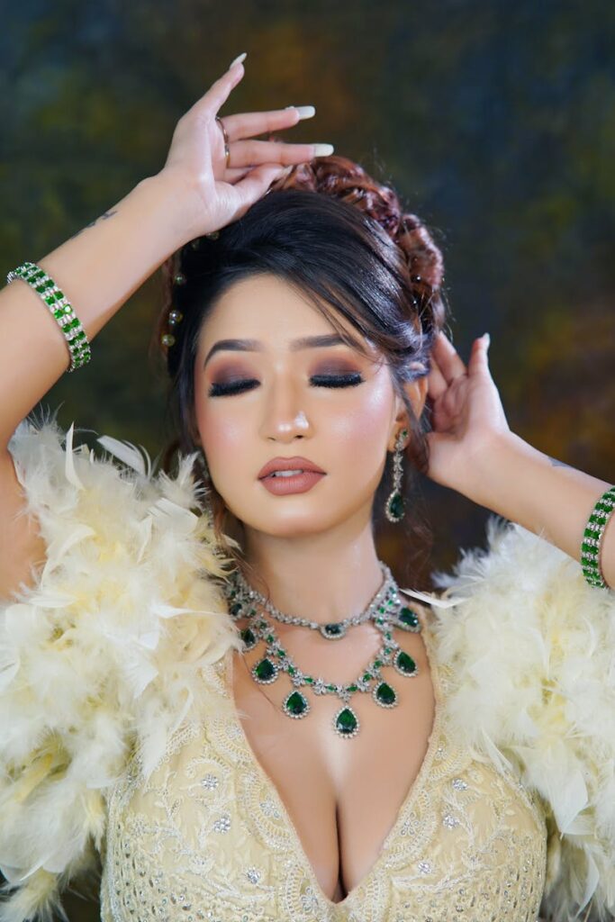 Close-up portrait of a woman with glamorous jewelry and makeup in a stylish pose.