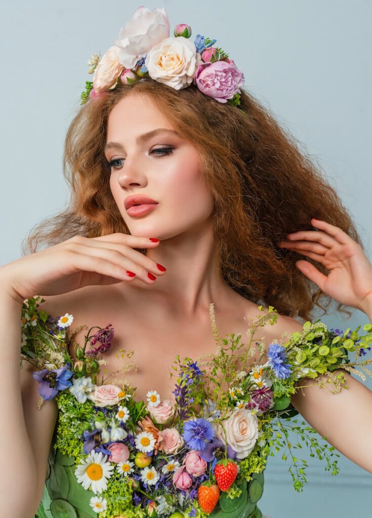 Elegant portrait of a woman adorned with vibrant flowers and a floral crown, exuding natural beauty.