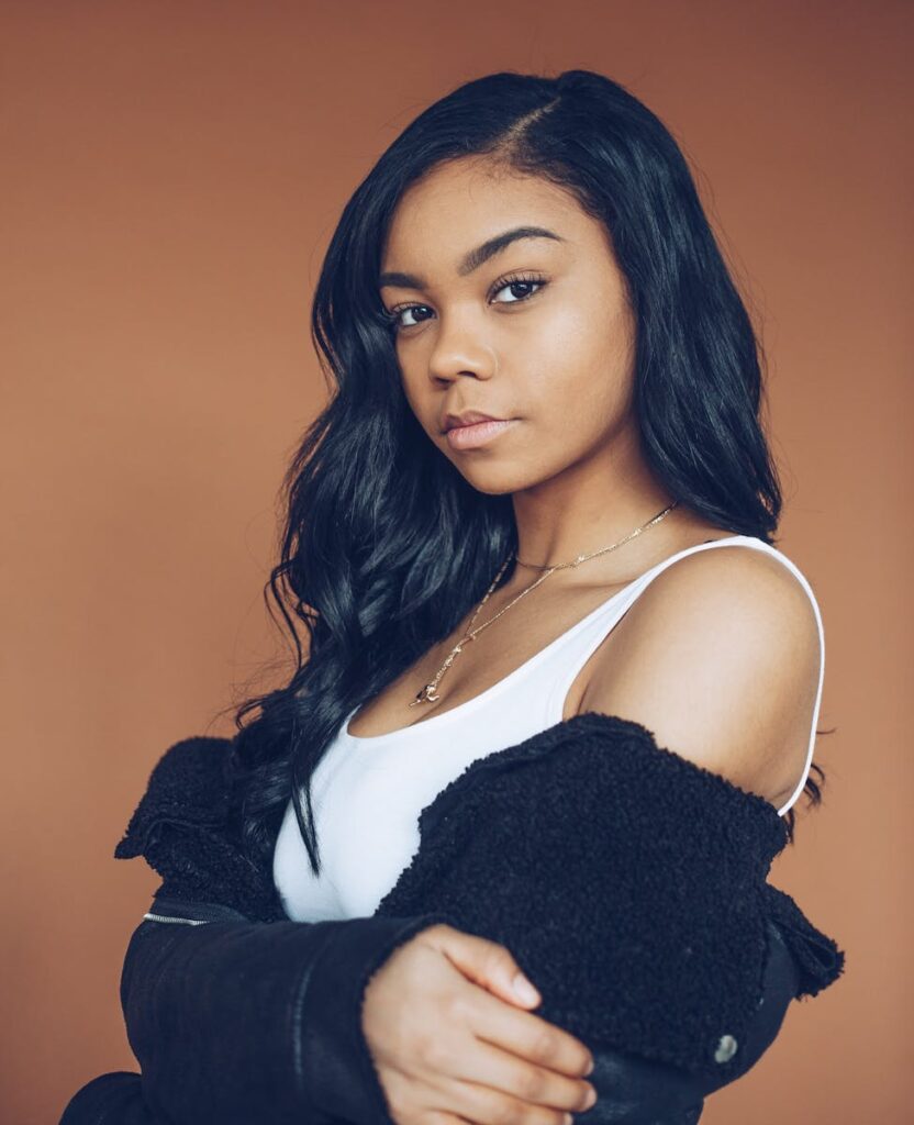 Stylish young black woman posing confidently in a fashionable outfit.