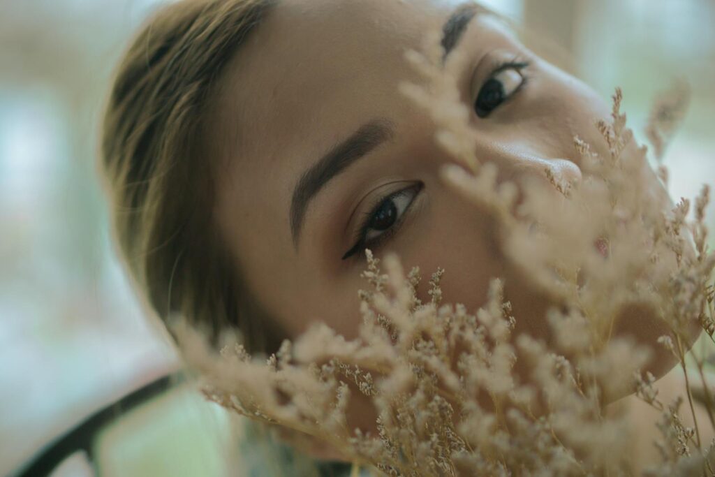 Close-up portrait of a woman with flowers, exuding tranquility.