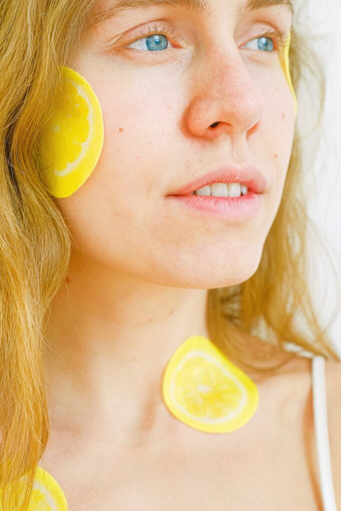 Closeup of young female with bright eyes looking away while having healthy skincare procedure and smiling while resting in studio