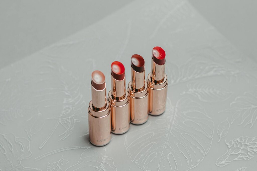 A stylish set of lipsticks arranged on a decorative textured surface, perfect for fashion and beauty themes.