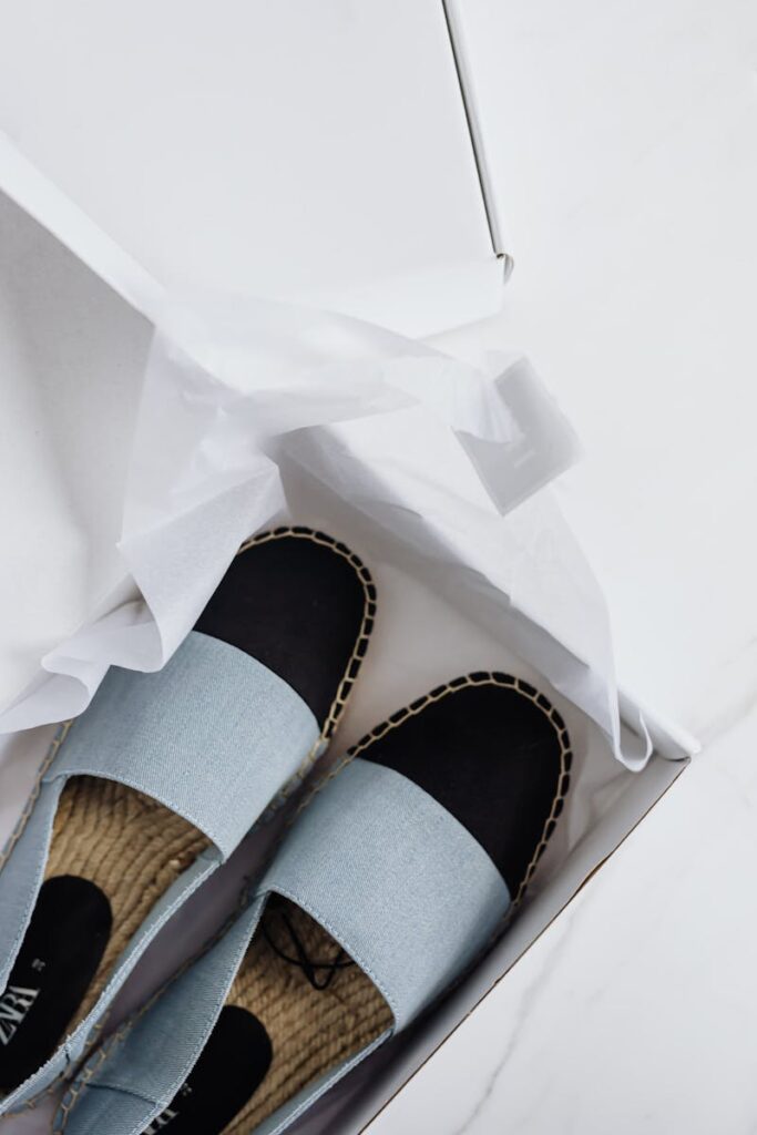 Elegant espadrilles in a box, showcasing fashion-forward style and online purchase convenience.