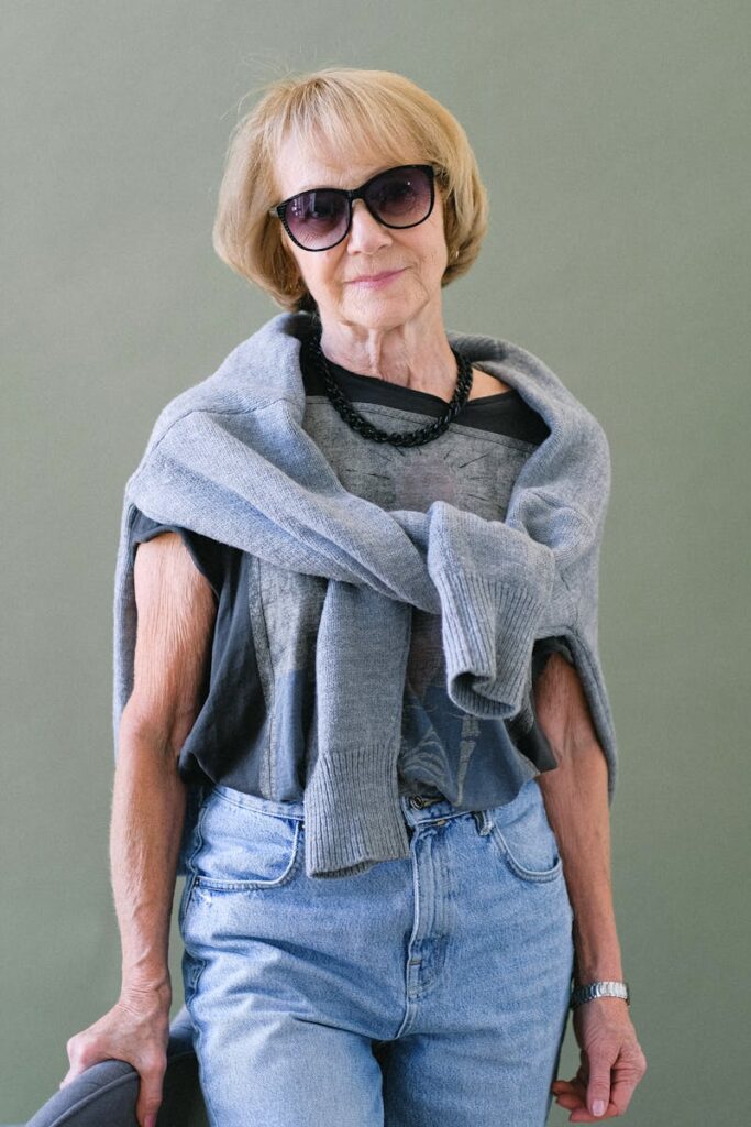 Stylish senior woman in a casual outfit posing confidently indoors.