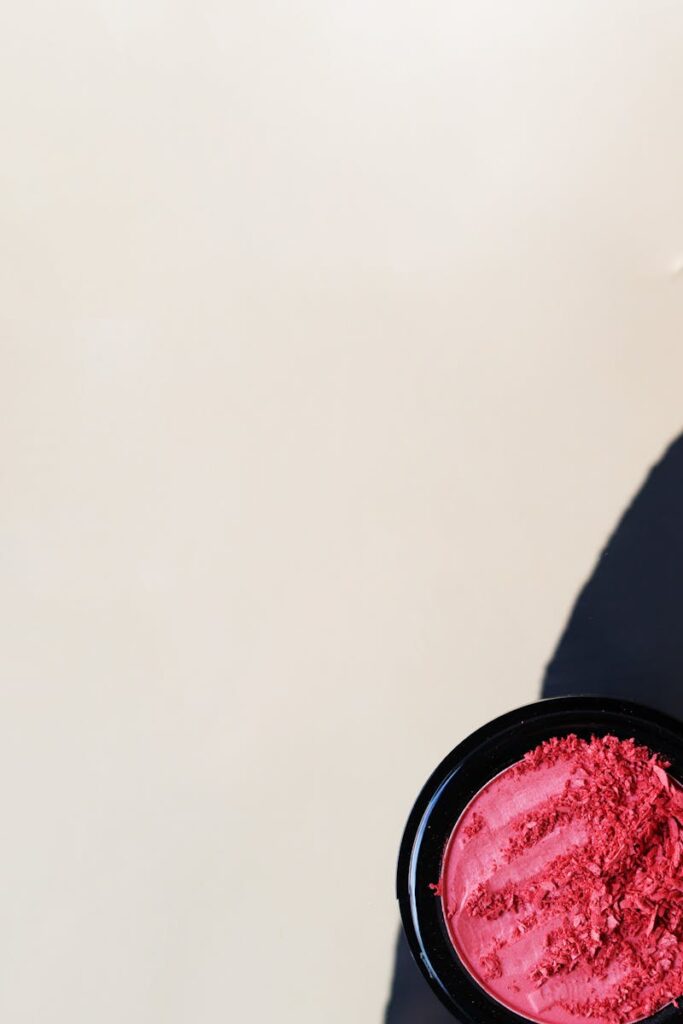 Pink cosmetic powder composition on a clean white backdrop, ideal for beauty products.