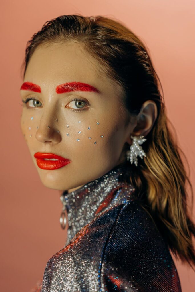 Stunning portrait of a woman with vibrant makeup and glitter fashion.