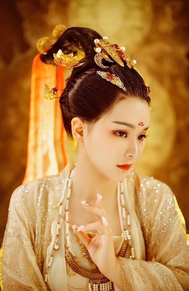 Elegant portrait of a woman in traditional Chinese costume with intricate golden details.