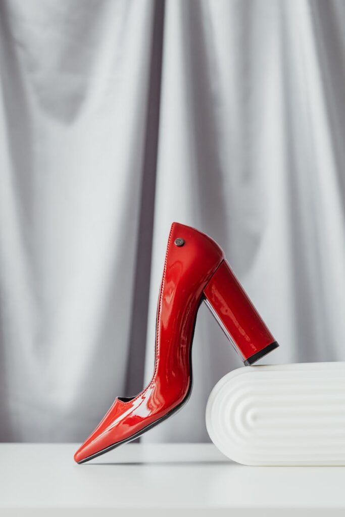 Stylish red high heel shoe captured in a professional product shot.