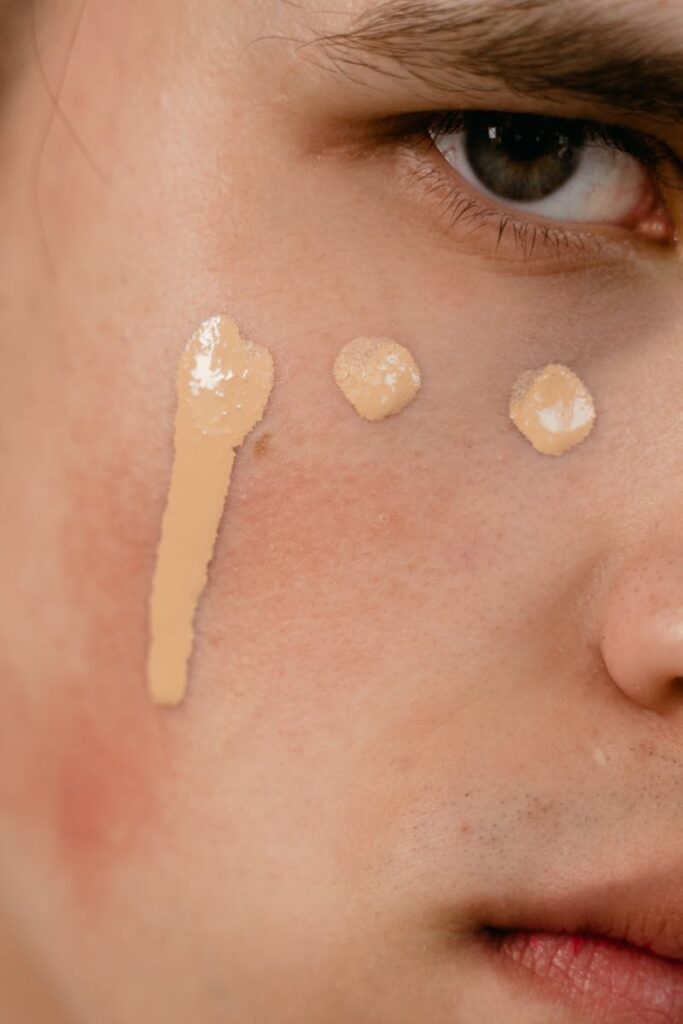Close-up image showing foundation makeup applied on a person's cheek.