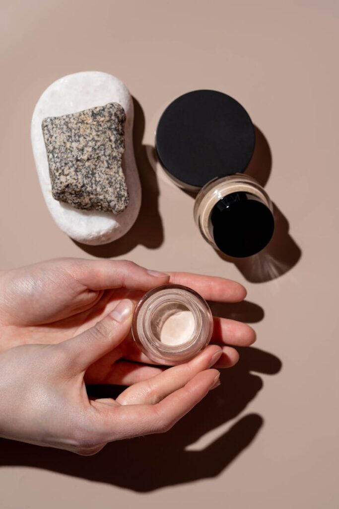 Minimalist display of skincare and cosmetic products with a focus on natural textures and elegance.