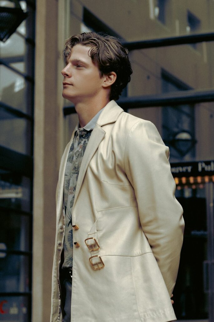 A man in a suit and tie standing on a sidewalk