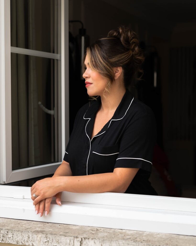 A woman is looking out of a window