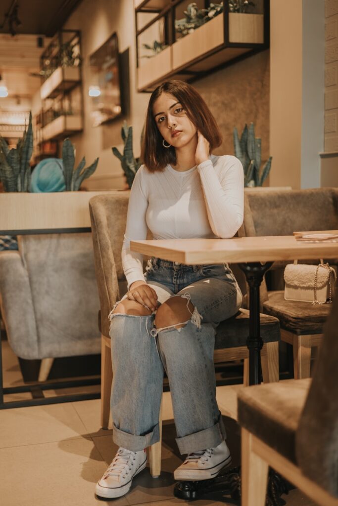 a woman sitting at a table in a restaurant