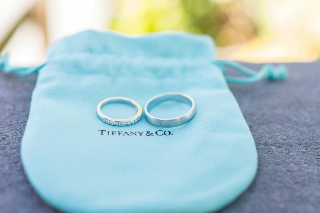 Two wedding rings on a Tiffany & Co. pouch, perfect for elegant jewelry presentations.