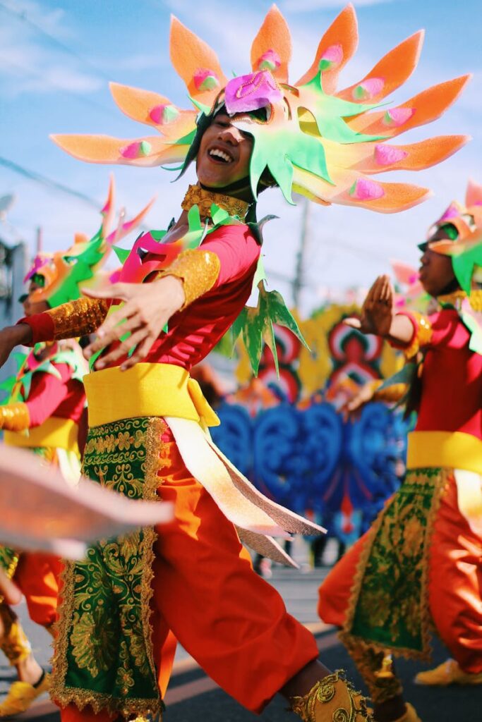 Colorful dancers in traditional attire celebrate the Gubat Festival outdoors.