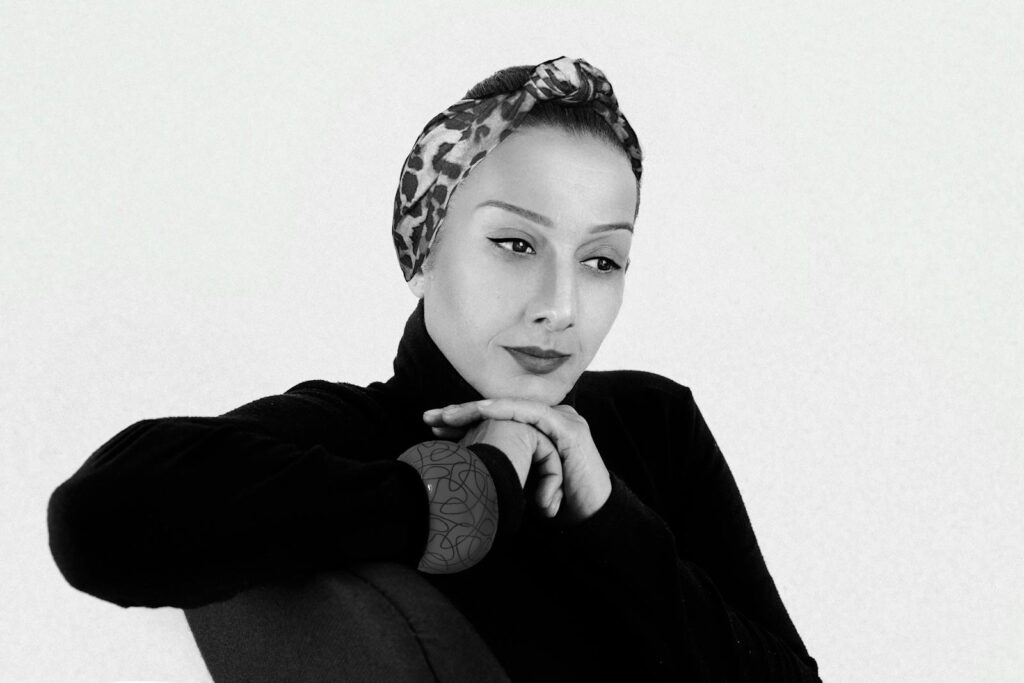 Elegant portrait of a woman with headband, deep in thought.