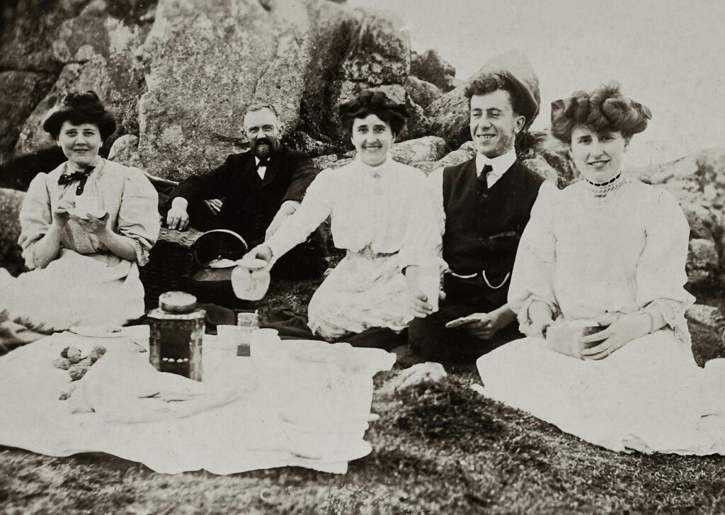 A charming vintage photo of a family enjoying a scenic outdoor picnic.