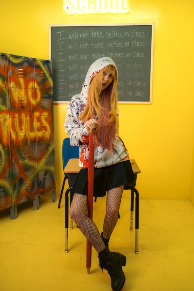 A stylish woman in a punk outfit poses confidently in a vibrant classroom setting with bold graffiti art.